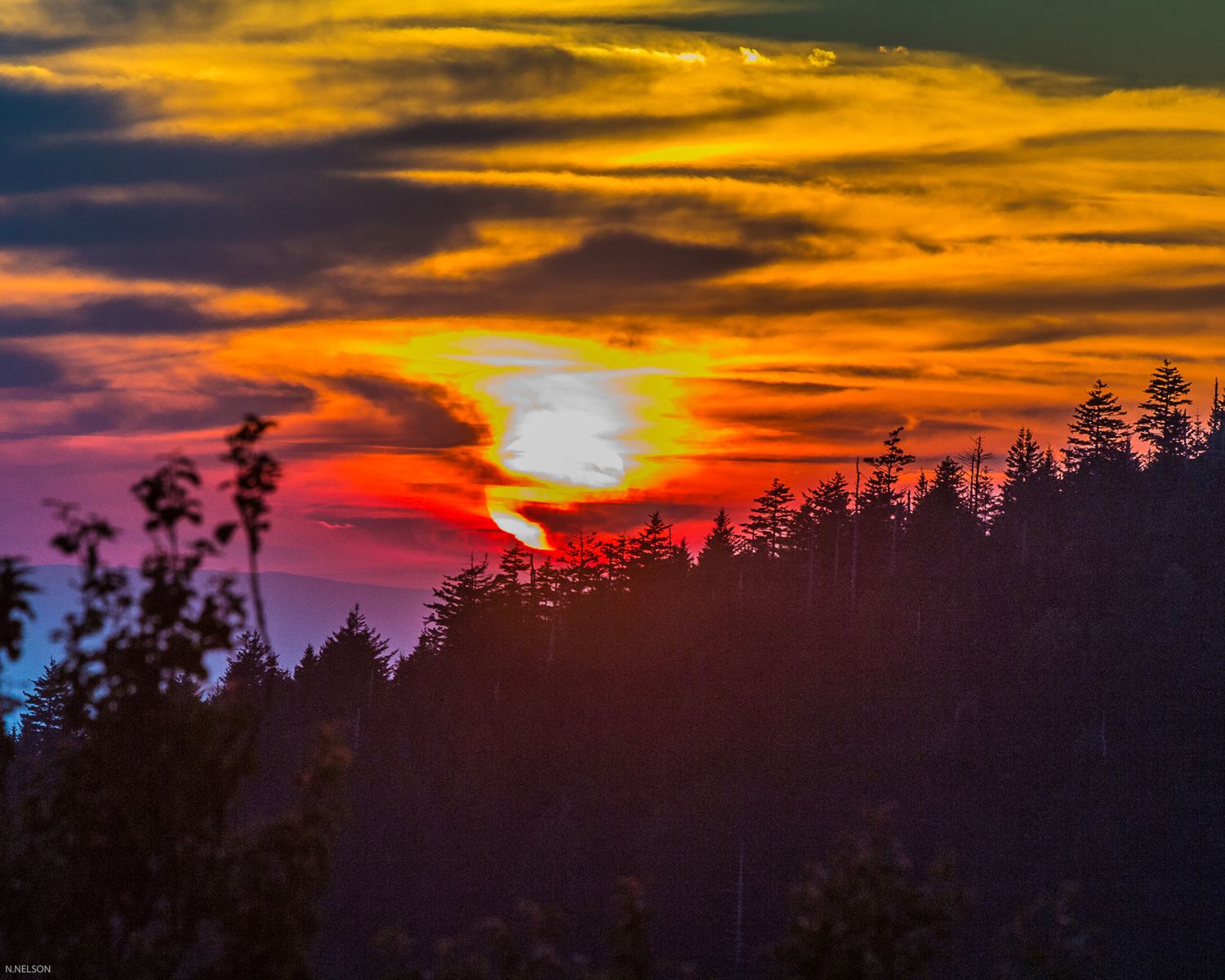 Sunset Over Forested Hills